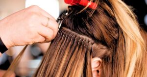 Hair extension in Ives Estates applied by professional stylist at Hair By Fleur, blending natural color, texture, and length for seamless results